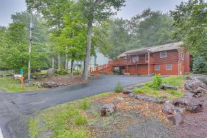 a house on a road in front of a house at Pocono Vacation Rental with Game Room! in Tobyhanna