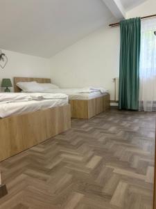 Di &D House #rai في Băniţa: غرفة نوم بسريرين وارضية خشبية