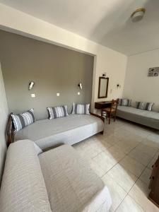 a hotel room with two beds and a table at Islands Apartments in Petra