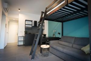 a living room with a couch and a loft bed at Oktò apartments Milazzo in Milazzo