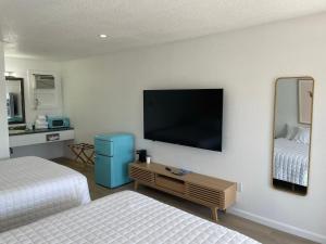 a hotel room with two beds and a flat screen tv at Double Room in Lake City