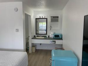 a room with a bed and a sink and a mirror at Double Room in Lake City