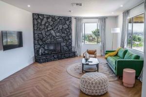 a living room with a green couch and a fireplace at Mojave Desert Pied-à-terre in Yucca Valley