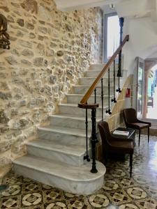a stone staircase in a room with a stone wall at Boutique B&B Número Cuatro in Benissa