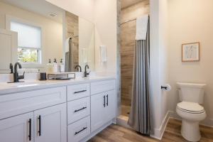 a white bathroom with a sink and a toilet at Piedmont Place Suite 304 - near vineyards! in Crozet +7 photos