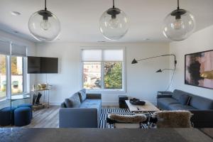 a living room with blue couches and a table at Piedmont Place Suite 304 - near vineyards! in Crozet