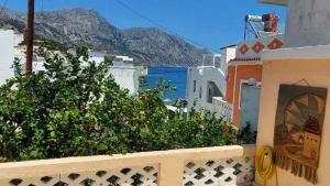 a balcony of a building with a view of the ocean at Captain John's Apartment in Diafani
