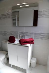 a bathroom with a white sink and a toilet at Saturne in Saint-Quentin +10 photos