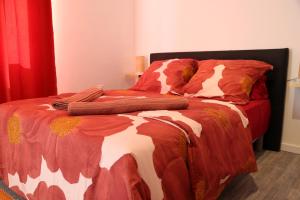 1 cama con edredón y almohadas en Saturne, en Saint-Quentin