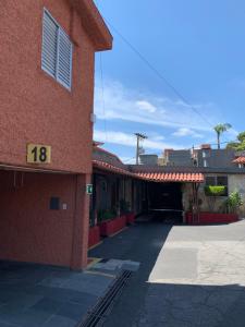 a red brick building with the number on it at Motel Cigano’s in Belo Horizonte