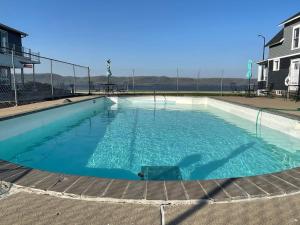 a large swimming pool with blue water at Poolside Double Rooms in Lake City