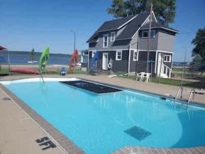 a large blue swimming pool in front of a house at 2nd Floor, 2 Bedroom Condo, Sleeps 6 in Lake City
