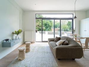 uma sala de estar com um sofá e uma mesa em Maison Cokoon em Bruxelas
