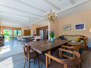 a dining room with a wooden table and chairs at Villa Benka, Istrian stone house in Tinjan