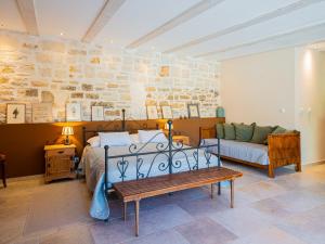 a bedroom with a bed and a couch at Villa Benka, Istrian stone house in Tinjan