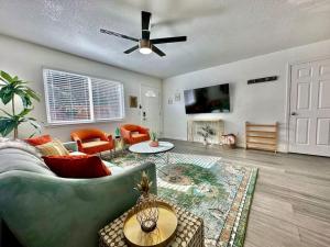 a living room with a couch and a ceiling fan at First floor gated, central and remodeled apartment in Sacramento