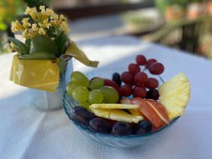 a bowl of fruit on a table with a vase of flowers at Apartments Terra Solaris in Medulin