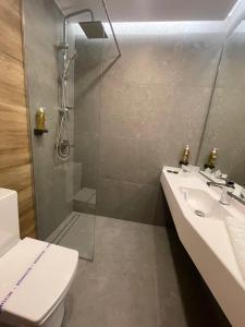 a bathroom with a shower and a sink and a toilet at Complex Hotelier Steaua de Mare - Hotel Delfinul in Eforie Nord +29 photos