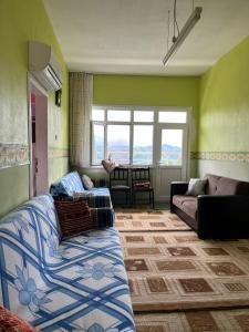 a living room with two couches and a window at a peaceful holiday in a village environment in İyidere