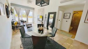 a living room with a dining table and chairs at Cana Rock Condos Rock & Roll Theme & Golf Course View - infinity Pool in Punta Cana