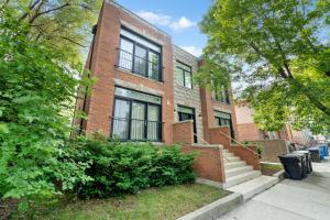 a brick building with a staircase in front of it at Spacious Luxury Retreat 8 Bed Oasis with 6 Baths in Chicago