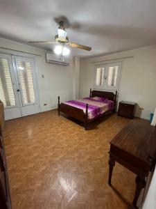 a bedroom with a bed and a ceiling fan at شقة في المعادي للاجار Maadi Apartement for rent in Cairo