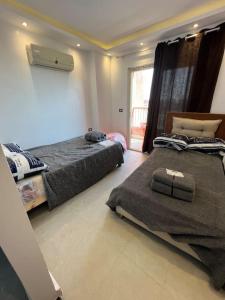 a bedroom with two beds and a window at استديو فى بورتو جولف مارينا in El Alamein