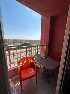 a balcony with a table and two chairs and a window at استديو فى بورتو جولف مارينا in El Alamein