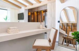a living room with a chair and a mirror at Puerto Banus Duplex Lux Selection in Marbella