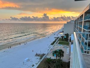 a view of the beach at sunset from a building at Ocean House 1806 in Gulf Shores