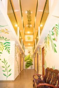 a hallway with paintings of plants on the walls at Hotel Caracas in Panama City