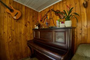 a wooden room with a piano and a guitar at Casa Rustica in Mamaia Nord +79 photos