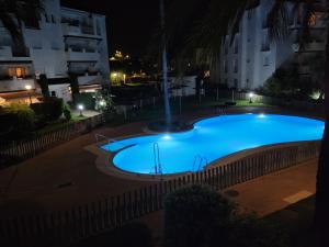 una gran piscina azul por la noche en costa ballena elite, en Costa Ballena