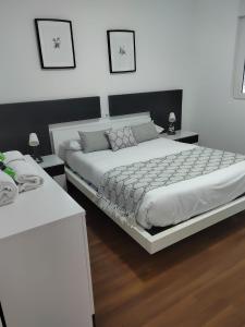 Apartamentos en Leis Muxia tesisinde bir odada yatak veya yataklar