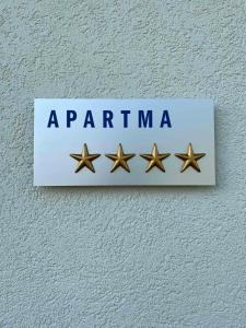 a sign on a wall with four gold stars at 47 Heaven Luxury House in Radovljica