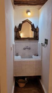 a bathroom with a sink and a mirror at Sel d Ailleurs, Atlas Mountain Retreat - adults only in Ouirgane