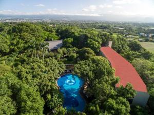 an aerial view of a house with a pool in the forest at Sumiya Cuernavaca in Cuernavaca