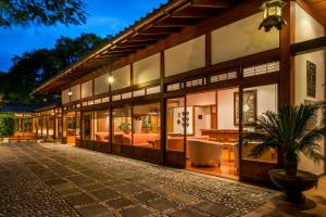 a house with glass doors and a potted plant at Sumiya Cuernavaca in Cuernavaca