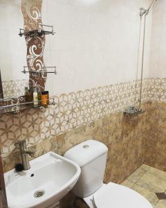 a bathroom with a toilet and a sink at Mira House in Martvili
