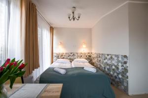 1 dormitorio con 1 cama verde y 2 almohadas en Pensjonat Agroturystyczny Premium Kraków Ojcowski Park Narodowy Cracovia Arabians, 