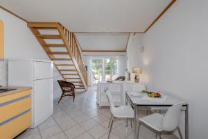 a kitchen and dining room with a table and chairs at Beachfront apartment with balcony and parking in Split