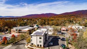 an aerial view of a town with mountains in the background at Piedmont Place Suite 401 Modern Apartment in Crozet Near King Family Vineyards in Crozet