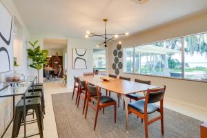 a dining room with a wooden table and chairs at Luxe Waterfront Oasis with Dock - Direct Lake Access! in Tavares