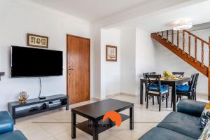a living room with a couch and a table at #167 Santa Eulália by Home Holidays in Branqueira
