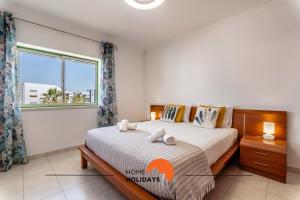 a bedroom with a bed and a large window at #167 Santa Eulália by Home Holidays in Branqueira