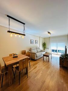 a living room with a table and a couch at MARINA LLANES V in Llanes +29 photos