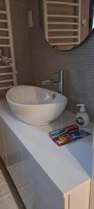 a white sink on a counter in a bathroom at Lux Apartment Jovanovic in Tivat