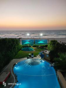 a swimming pool with a view of the ocean at Resort altayar Villa altayar 1 Aqua Park with Sea View in Sidi Krir 