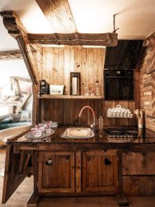a kitchen with a sink and a counter top at Altholz-Apartment in Ramsau