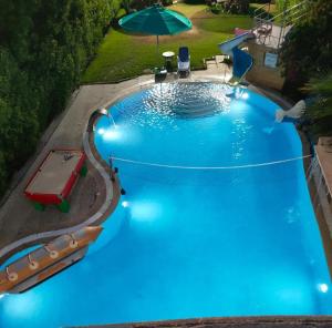 an overhead view of a large blue swimming pool with an umbrella at Resort altayar Villa altayar 1 Aqua Park with Sea View in Sidi Krir 